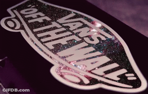A Close Up Of A Vans Logo On A Purple Surface GIF
