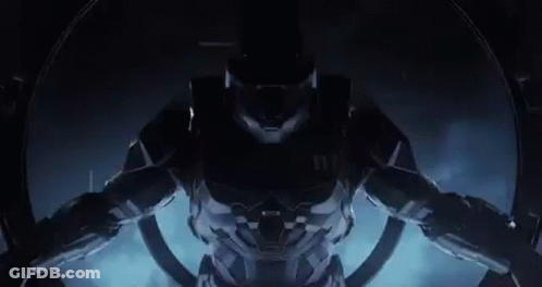 A Close Up Of A Video Game Character In A Futuristic Suit Standing In A Dark Room . GIF
