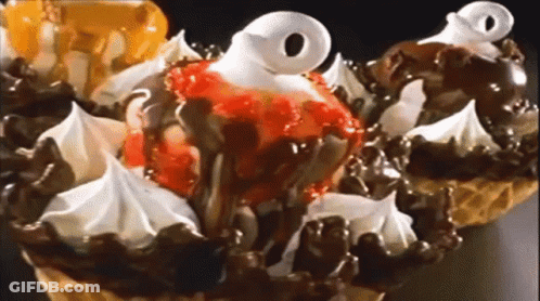 A Close Up Of A Waffle Cone With Ice Cream And Whipped Cream On Top GIF