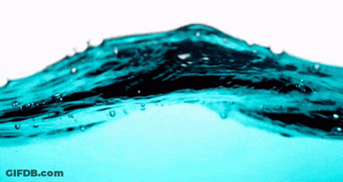 A Close Up Of A Wave Of Blue Water With Bubbles GIF