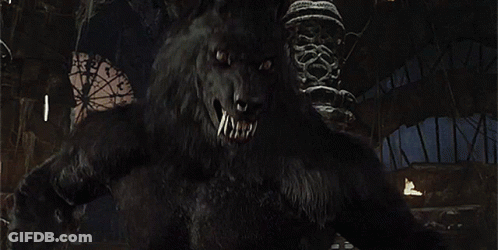 A Close Up Of A Werewolf With Its Mouth Open And Teeth . GIF