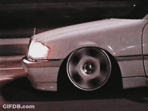A Close Up Of A White Car With A Lowered Stance GIF