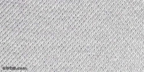 A Close Up Of A White Fabric With Three White Dots . GIF