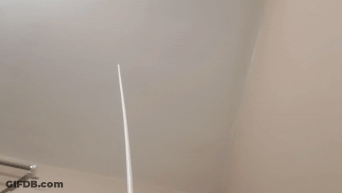 A Close Up Of A White Wall With A Towel Rack GIF