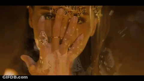 A Close Up Of A Woman Covering Her Face With Her Hand And Wearing Rings . GIF