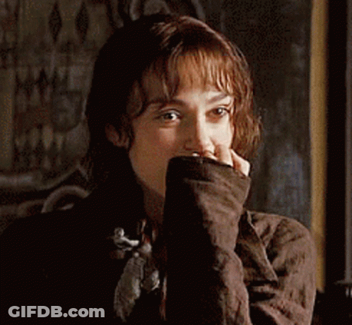 A Close Up Of A Woman Covering Her Face With Her Hands GIF