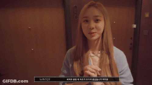 A Close Up Of A Woman Covering Her Mouth With Her Hands And A Gifsaespa Watermark GIF
