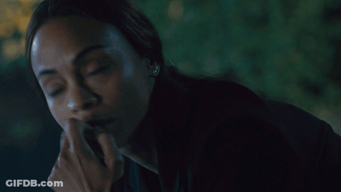 A Close Up Of A Woman Covering Her Mouth With Her Hands GIF