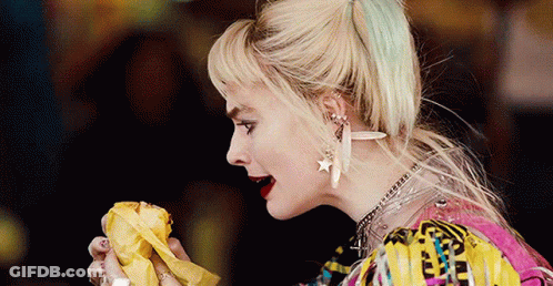 A Close Up Of A Woman Eating A Banana In A Movie . GIF