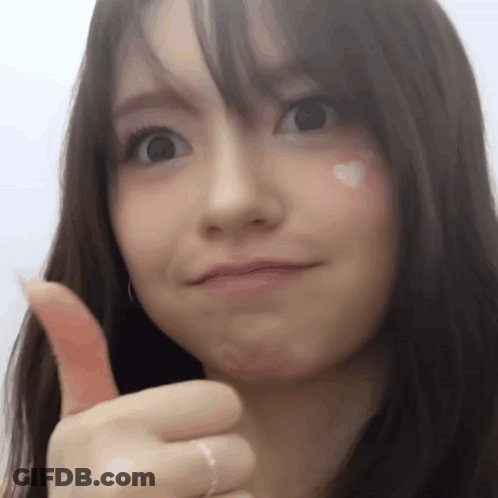 A Close Up Of A Woman Giving A Thumbs Up Sign GIF