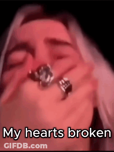 A Close Up Of A Woman Holding A Ring In Her Hand With The Words `` My Hearts Broken '' . GIF