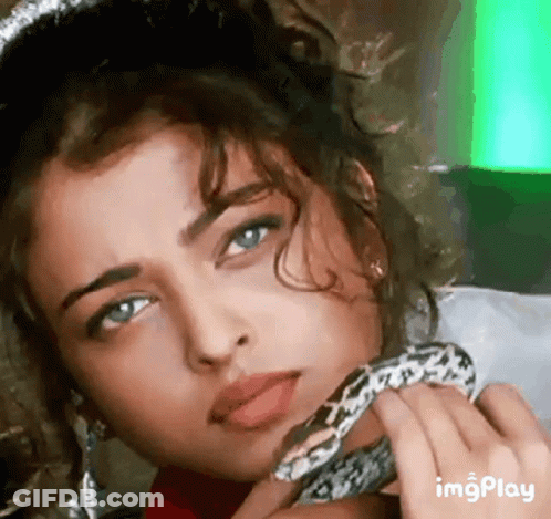 A Close Up Of A Woman Holding A Snake Around Her Neck GIF