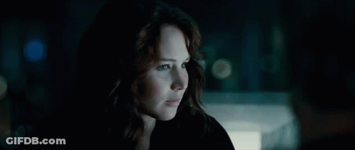 A Close Up Of A Woman In A Dark Room GIF