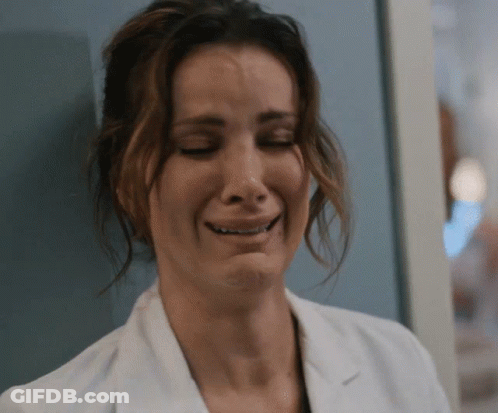 A Close Up Of A Woman In A Lab Coat Crying GIF