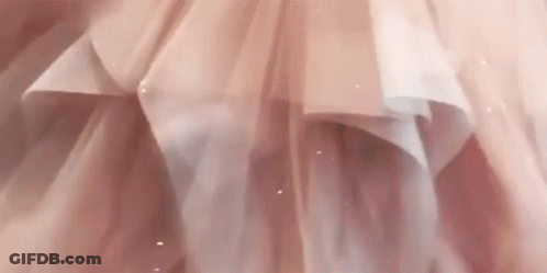 A Close Up Of A Woman In A Pink Dress GIF