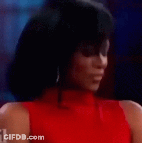 A Close Up Of A Woman In A Red Dress Smiling . GIF