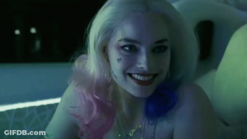 A Close Up Of A Woman In A Suicide Squad Costume Smiling . GIF