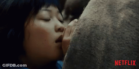 A Close Up Of A Woman Kissing A Rock With Netflix Written In Red On The Bottom GIF