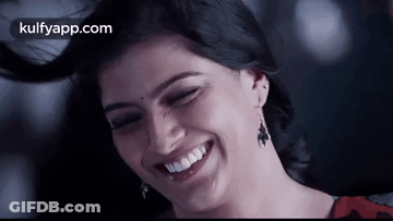 A Close Up Of A Woman Laughing With Her Eyes Closed . GIF