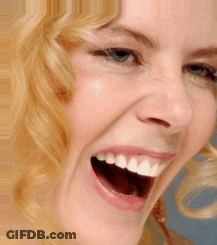 A Close Up Of A Woman Laughing With Her Mouth Open GIF
