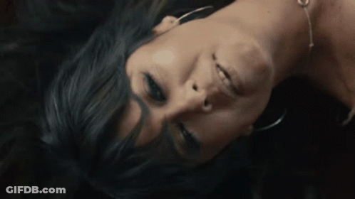 A Close Up Of A Woman Laying Face Down GIF