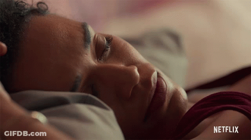 A Close Up Of A Woman Laying In Bed With Netflix Written On The Bottom GIF