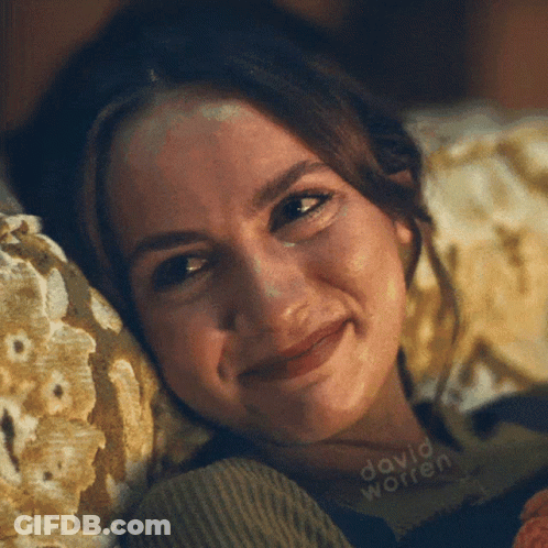 A Close Up Of A Woman Laying On A Couch With The Name David Worren Written On The Bottom GIF
