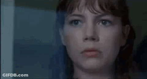 A Close Up Of A Woman Looking Out Of A Window . GIF