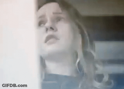A Close Up Of A Woman Looking Up At Something . GIF