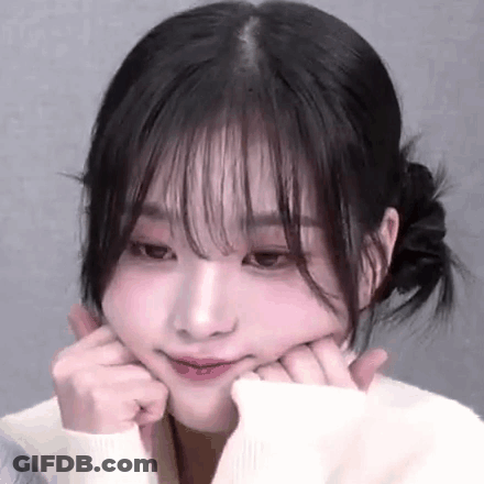 A Close Up Of A Woman Making A Face With Her Hands On Her Face . GIF