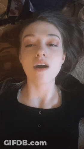 A Close Up Of A Woman Making A Face With Her Mouth Open GIF