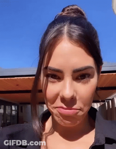 A Close Up Of A Woman Making A Face With Her Mouth Open GIF
