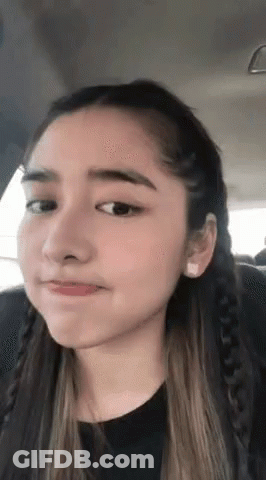 A Close Up Of A Woman Making A Funny Face GIF