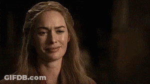 A Close Up Of A Woman Making A Funny Face In The Dark . GIF