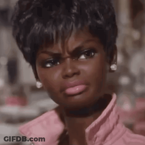 A Close Up Of A Woman Making A Funny Face Wearing A Pink Jacket GIF