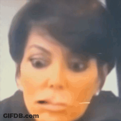 A Close Up Of A Woman Making A Funny Face While Looking At Herself In The Mirror . GIF