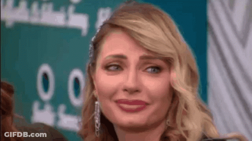 A Close Up Of A Woman Making A Funny Face With Her Eyes Closed . GIF