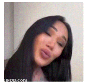 A Close Up Of A Woman Making A Funny Face With Her Eyes Closed . GIF