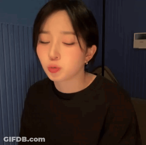 A Close Up Of A Woman Making A Funny Face With Her Eyes Closed GIF