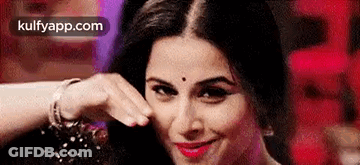A Close Up Of A Woman Making A Funny Face With Her Hand On Her Face . GIF