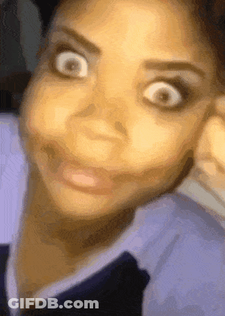 A Close Up Of A Woman Making A Funny Face With Her Hand On Her Face GIF