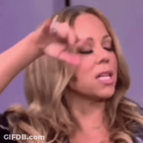 A Close Up Of A Woman Making A Funny Face With Her Hand On Her Forehead . GIF