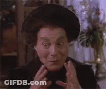 A Close Up Of A Woman Making A Funny Face With Her Hands On Her Face . GIF