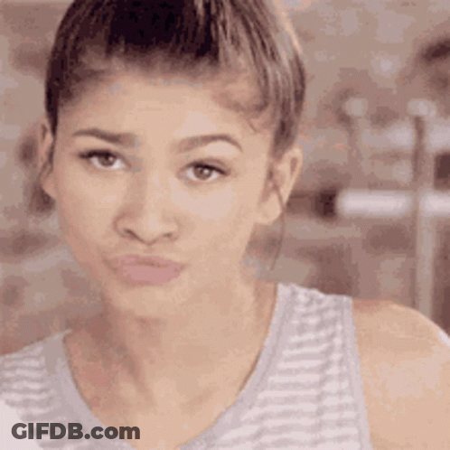 A Close Up Of A Woman Making A Funny Face With Her Mouth Open . GIF