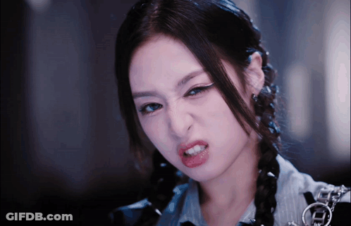 A Close Up Of A Woman Making A Funny Face With Her Mouth Open GIF