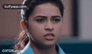 A Close Up Of A Woman Making A Funny Face With Her Mouth Open . GIF