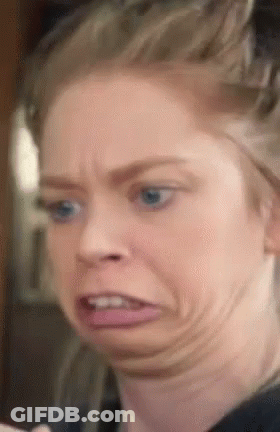 A Close Up Of A Woman Making A Funny Face With Her Mouth Open GIF