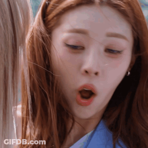 A Close Up Of A Woman Making A Funny Face With Her Mouth Open GIF