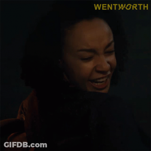 A Close Up Of A Woman Making A Funny Face With The Word Wentworth Behind Her GIF