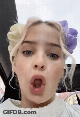 A Close Up Of A Woman Making A Funny Face GIF